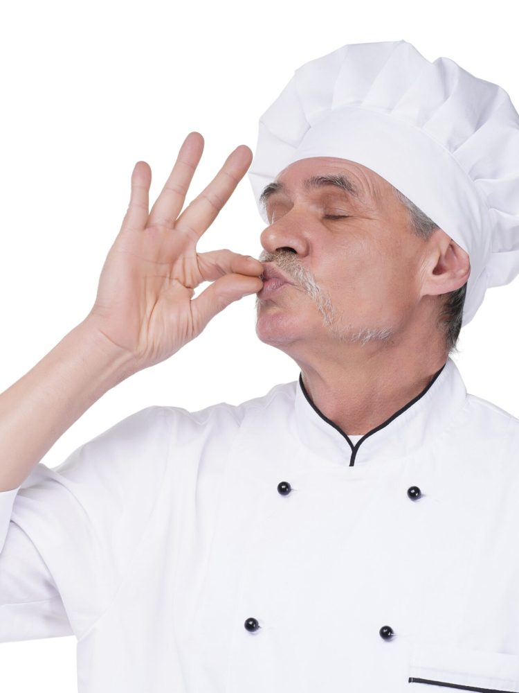 Image of handsome bearded senior man chef indoors isolated over white wall background.